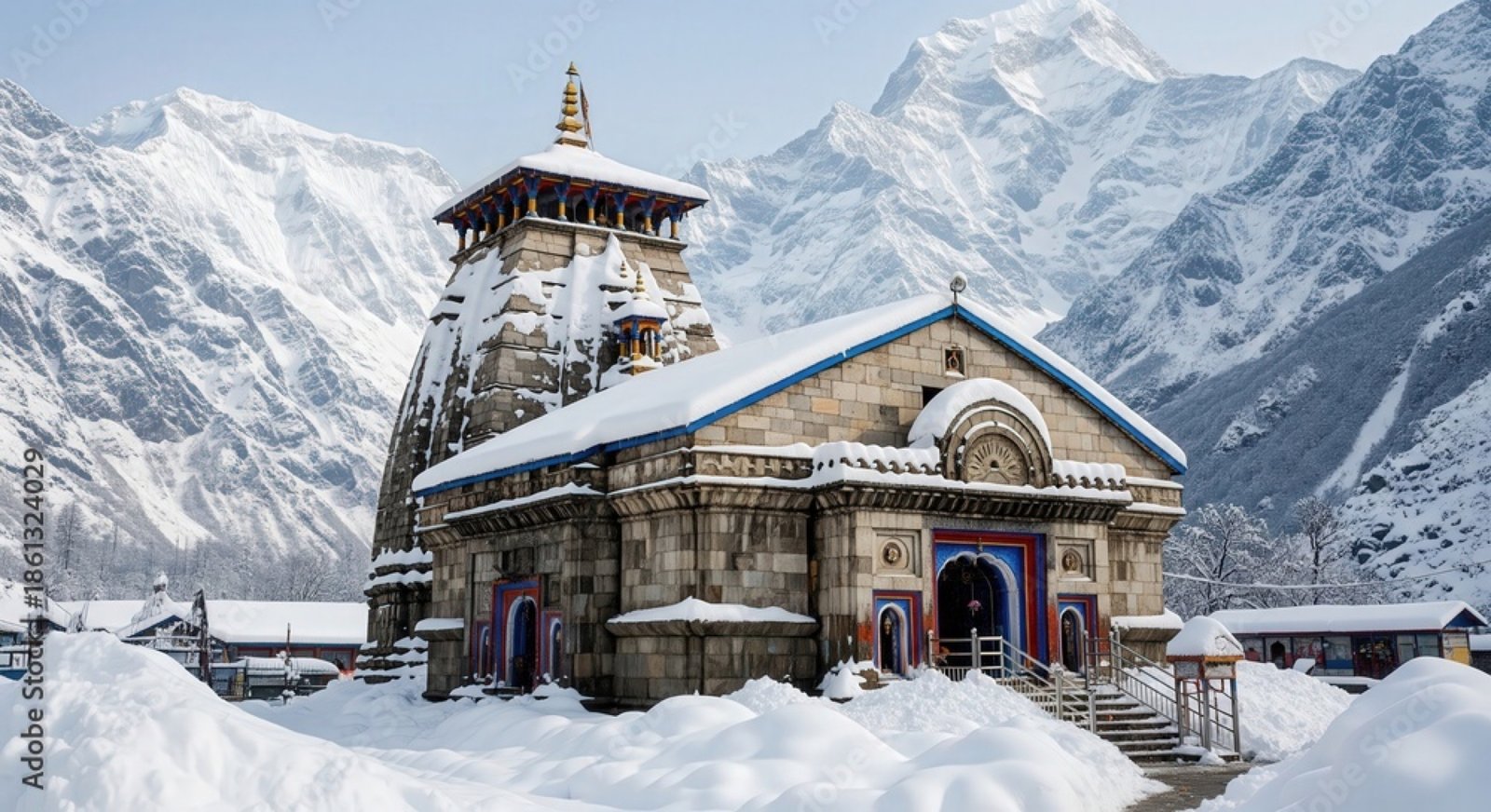 Kedarnath temple surrounded by snow-covered Himalayan peaks at sunrise